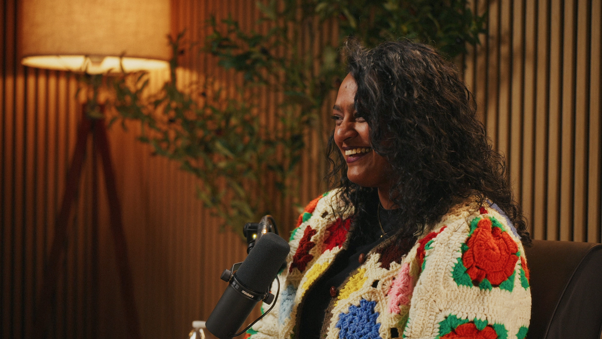 A guest laughing while she tells a story on the Ethos set