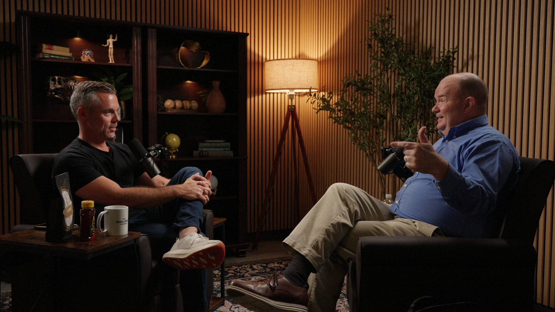 Wide shot of the Ethos set with a host and guest in the armchairs